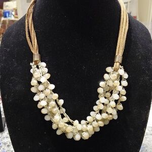 Chic Cream Beaded Necklace. Leather strands,opaque faceted beads,has an extender